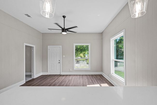 Entryway featuring healthy amount of natural light, wood finished floors, and ceiling fan | Image 10