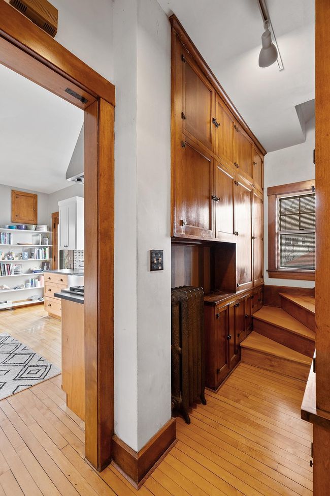Back stair and pantry area with original cabinetry and lots of storage. | Image 27
