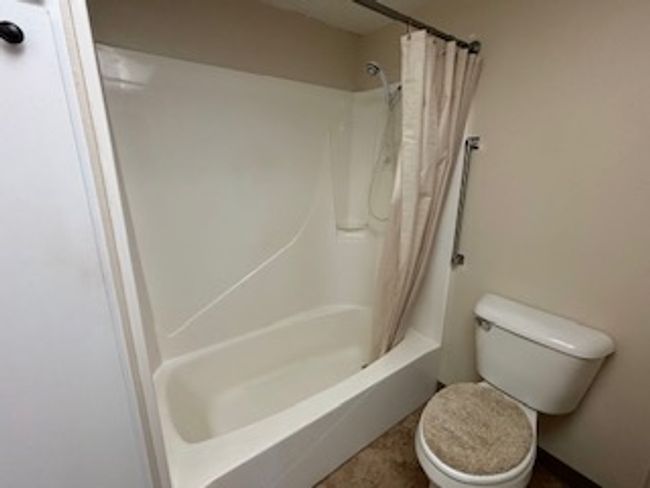 Full bathroom with toilet and shower / bathtub combination with curtain | Image 11