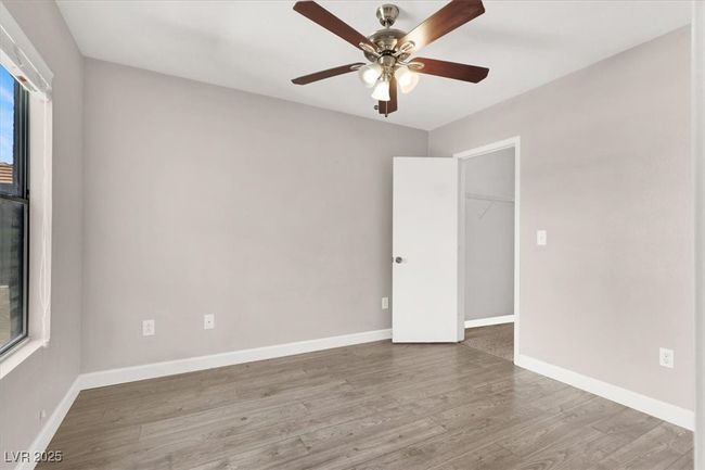 Unfurnished room with ceiling fan, baseboards, wood finished floors, and a wealth of natural light | Image 19