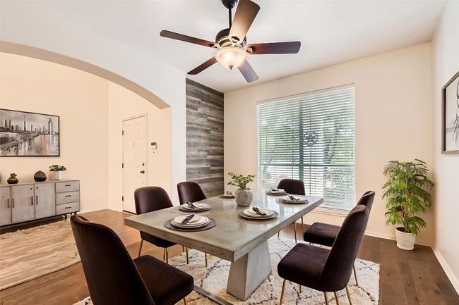 Dining area with arched walkways, ceiling fan, and wood finished floors (virtual staging) | Image 6