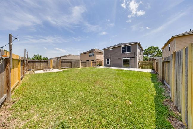 Direct access from the kitchen to the patio deck enhances indoor-outdoor flow for easy entertaining. | Image 33