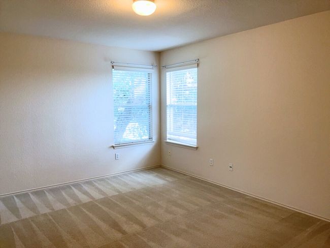 Bedroom featuring natural light and light colored carpet | Image 23