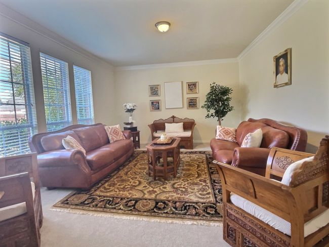Living area featuring ornamental molding and carpet | Image 4