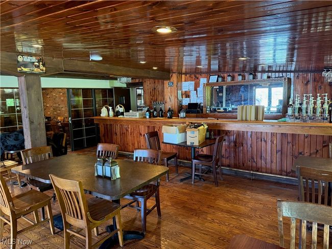 Dining area with wood finished floors and wood walls | Image 34