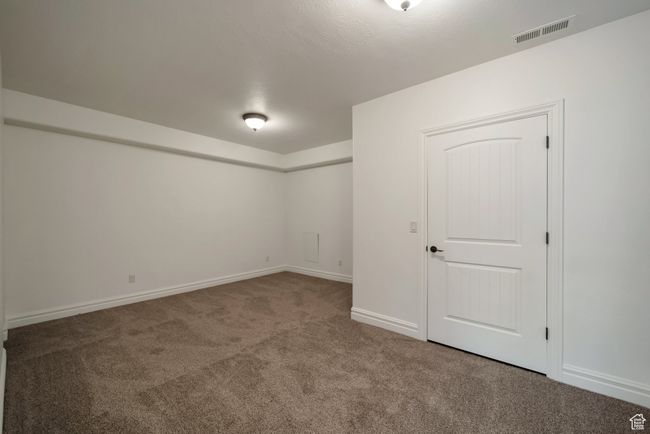 Basement with carpet flooring, visible vents, and baseboards | Image 30