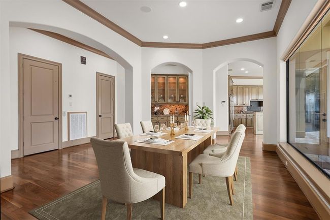 From dining area to the the living room, each space flows effortlessly into the next, allowing for both grand entertaining and intimate family gatherings. Virtually staged. | Image 15