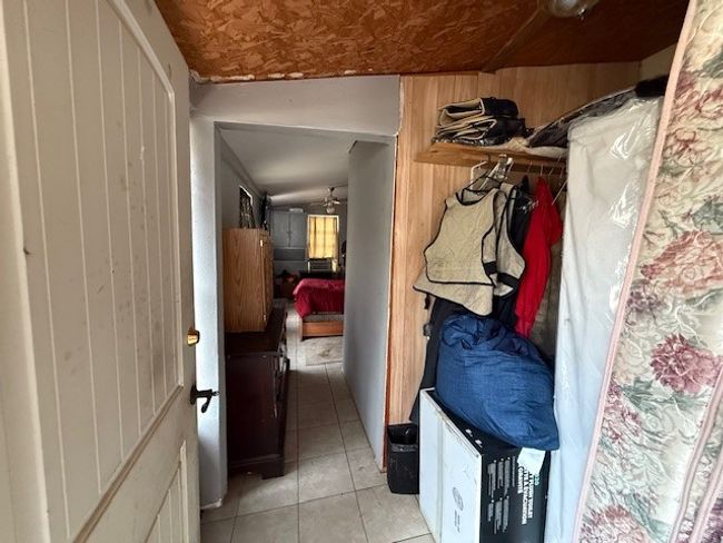 Mudroom with wood walls leading to bedroom | Image 18