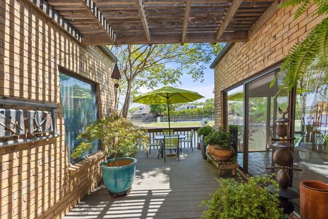 Wooden terrace with outdoor dining space and a pergola | Image 5