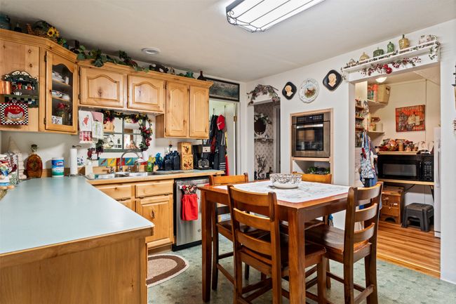 Kitchen featuring light countertops and appliances with stainless steel finishes | Image 22