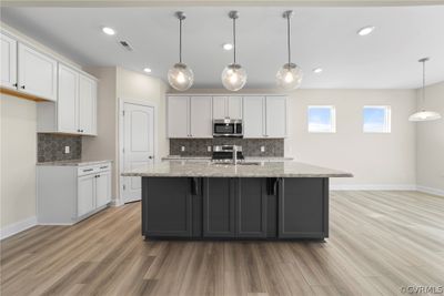 Photo represents the plan, not the actual home. Design selections may vary. The kitchen features an island and walk-in pantry. | Image 3