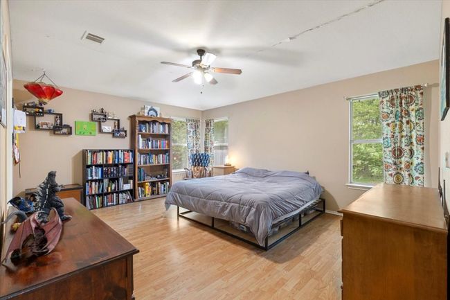 Bedroom featuring light wood finished floors and ceiling fan | Image 19