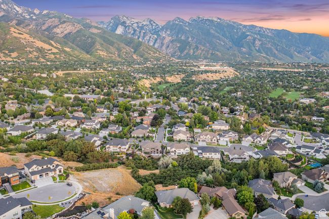 Aerial view of property's location with a mountain backdrop and nearby suburban area | Image 13