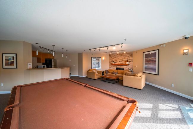 Rec room with track lighting, billiards, carpet floors, and a fireplace | Image 37