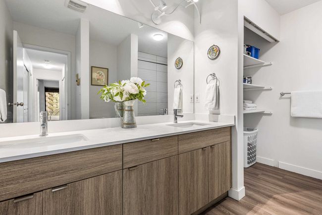 Bathroom with double vanity, wood finished floors, visible vents, and a sink | Image 19