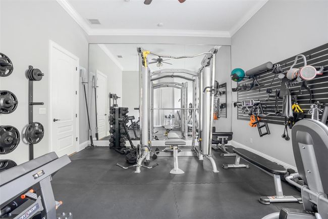Currently configured as a home gym, this versatile fifth bedroom features ample space, a mirrored wall, and durable flooring—easily adaptable to suit your lifestyle needs. | Image 23