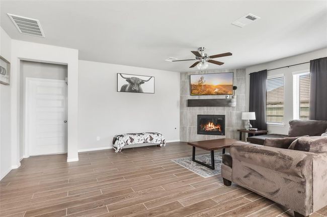 Modern tiled fireplace gives the space sophistication and warmth. | Image 16