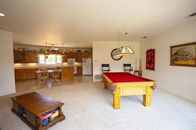 Living room featuring a tiled fireplace and carpet flooring | Image 17