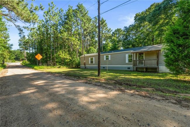 View of side of home with a porch and a yard | Image 7