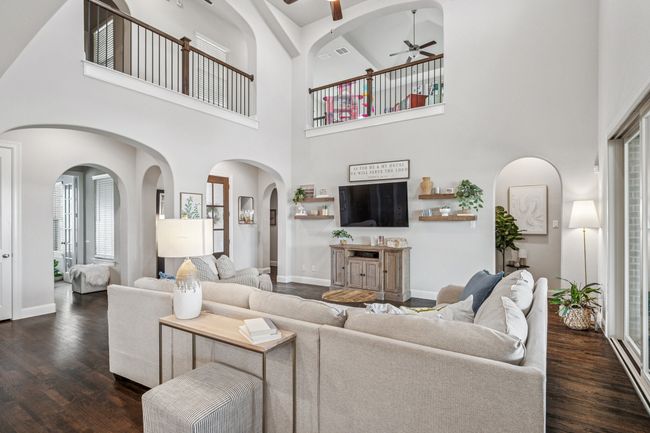Living area featuring visible vents, dark wood-style floors, baseboards, and ceiling fan | Image 11