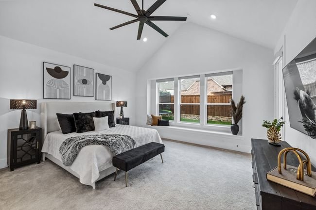 Carpeted bedroom with ceiling fan and high vaulted ceiling | Image 19