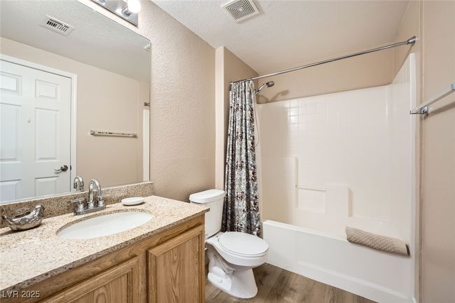 Bathroom featuring toilet, vanity, wood finished floors, and visible vents | Image 20