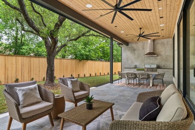 The oversized covered back patio includes a built-in grill. | Image 27