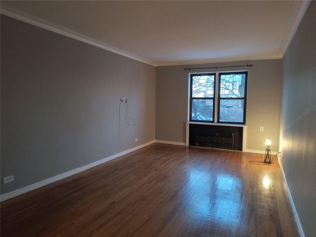 Empty room featuring baseboards, dark wood finished floors, and ornamental molding | Image 40