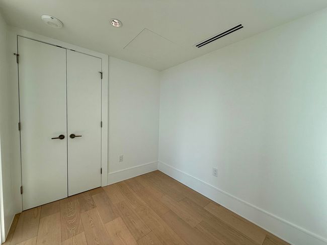 Unfurnished bedroom with light wood finished floors, baseboards, visible vents, and a closet | Image 9