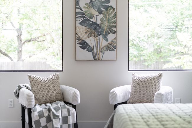 The primary bedroom is large enough to accommodate a cozy and inviting sitting area. | Image 24