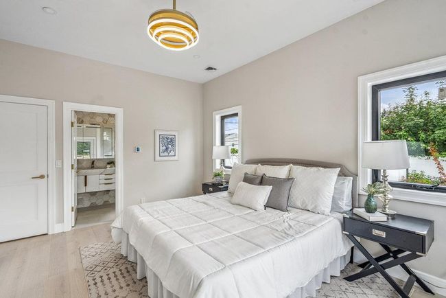 Sunlit Bedroom with vaulted ceiling and light Hardwood flooring, Recess Lighting, Walk-in Closets | Image 26