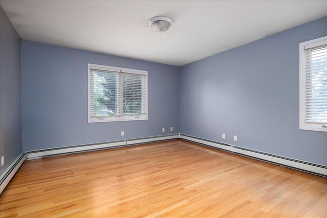Unfurnished room with wood finished floors | Image 16