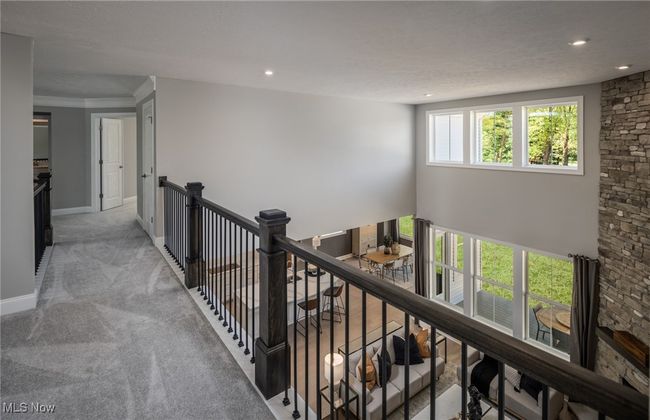 Loft overlooks the main living area with numerous windows. | Image 10