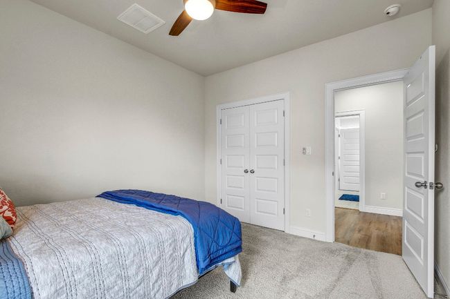 Bedroom featuring carpet, ceiling fan, and a closet | Image 31