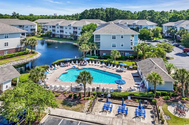 Aerial perspective of suburban area with a nearby body of water and a pool | Image 25