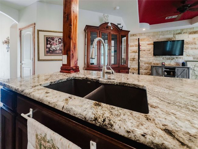 Kitchen featuring light stone countertops and arched walkways | Image 11