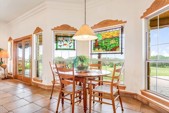 Tiled dining area featuring crown molding | Image 12