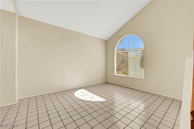 Unfurnished room with vaulted ceiling, light tile patterned floors, and baseboards | Image 7