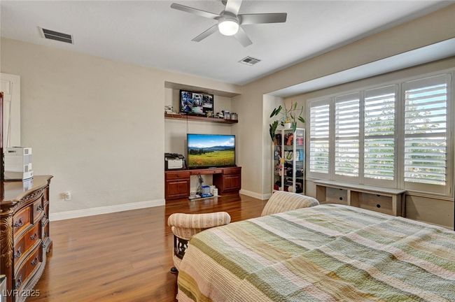 Bedroom featuring wood finished floors and ceiling fan | Image 38