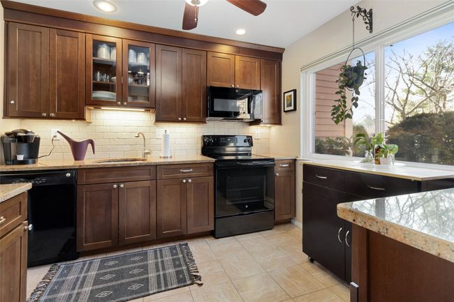Updated Kitchen with wood cabinets, granite countertops, tile flooring and ceiling fan | Image 4