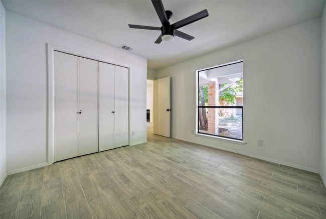 Unfurnished bedroom with light wood-style floors, a closet, and ceiling fan | Image 15