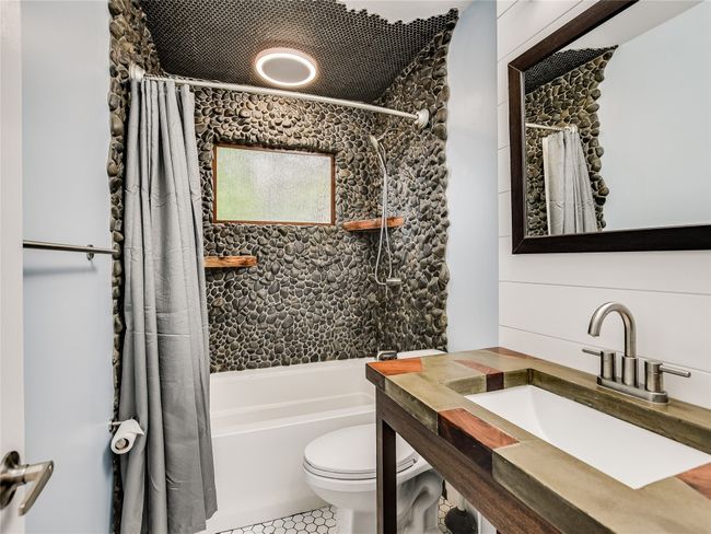 Full bathroom featuring toilet, tile patterned floors, shower / bath combo, and a sink | Image 15