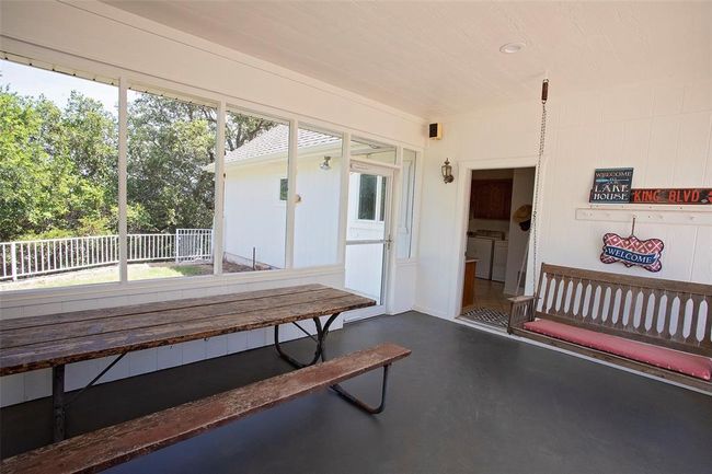 View of front of property featuring a playground, a front yard, and a garage | Image 7