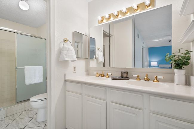 Full bath with toilet, a sink, and a stall shower | Image 21