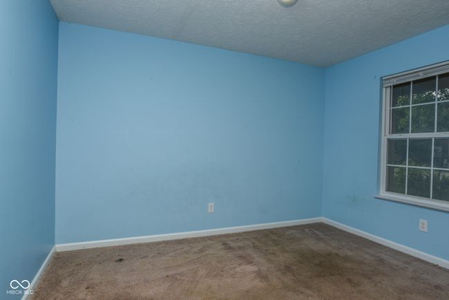 carpeted empty room with baseboards, plenty of natural light, and a textured ceiling | Image 12