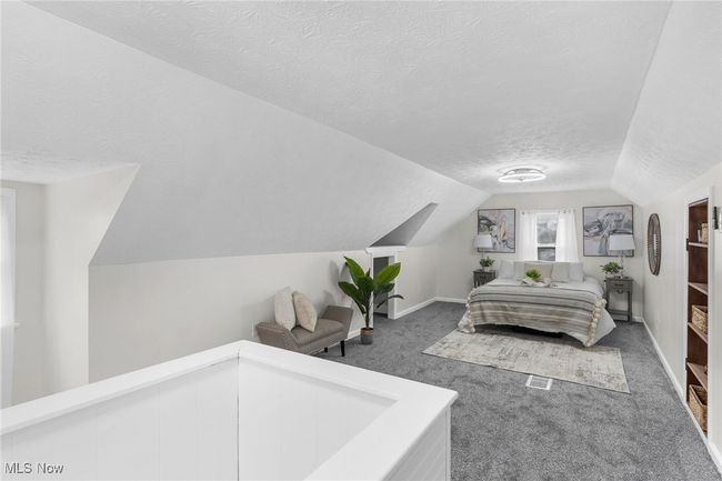 Bedroom featuring vaulted ceiling, a textured ceiling, and dark colored carpet | Image 9