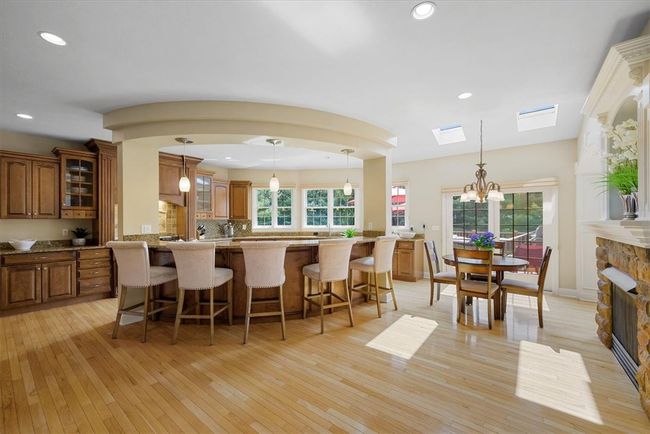 The gourmet kitchen features a large island with seating. | Image 15