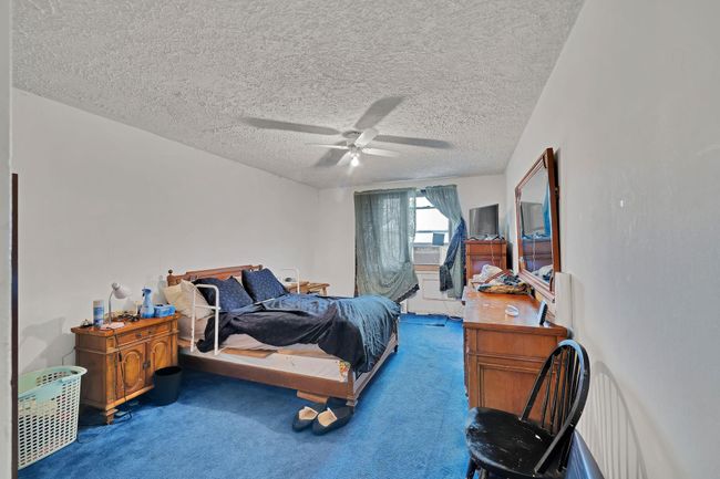 Carpeted bedroom featuring a textured ceiling and ceiling fan | Image 5