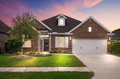 Welcome home to 10010 Starry Night Lane located on a quiet street in Meridiana and zoned to Alvin ISD! This stunning home has lovely curb appeal, a well-manicured lawn, beautiful landscaping, brick elevation, dark stained front door, covered front porch, traditional style, shutters, beautiful outdoor lanterns and a double wide driveway! | Image 1