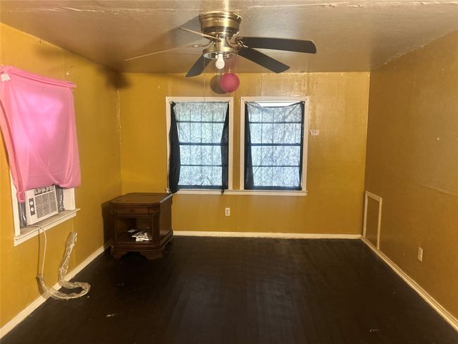 Empty room with ceiling fan and wood finished floors | Image 7